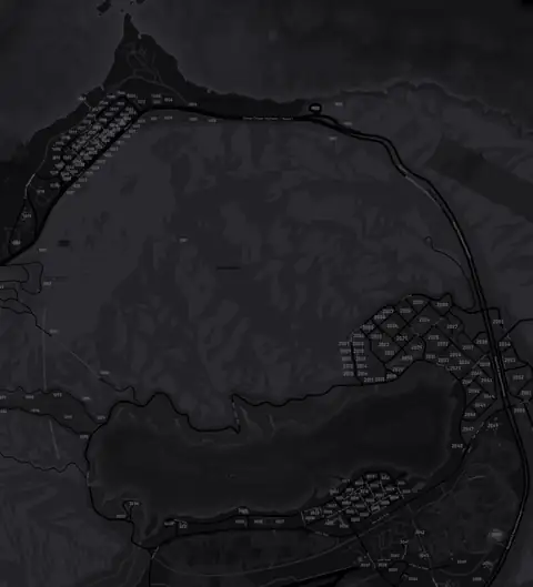 The north of the county on the DRILL UK pause map in grey: the coast town in the top left, a grid of streets to the east and a lakeside town on the shore at the bottom
