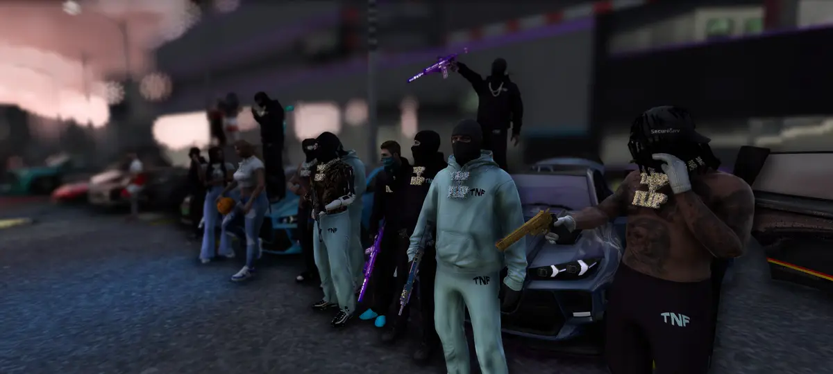 A Drill UK crew in matching hoodies lined up in front of their cars at dusk