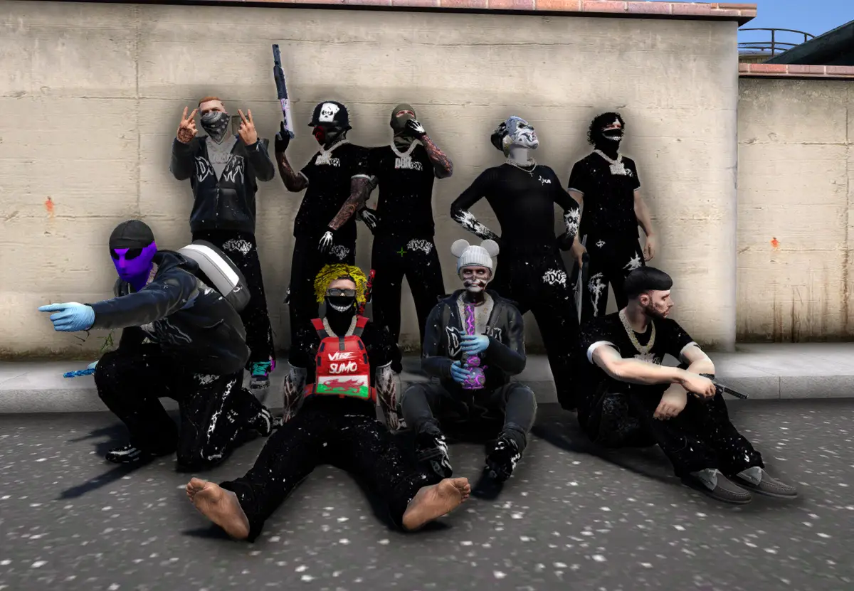 A Drill UK crew in matching black outfits with white paint markings posing against a wall