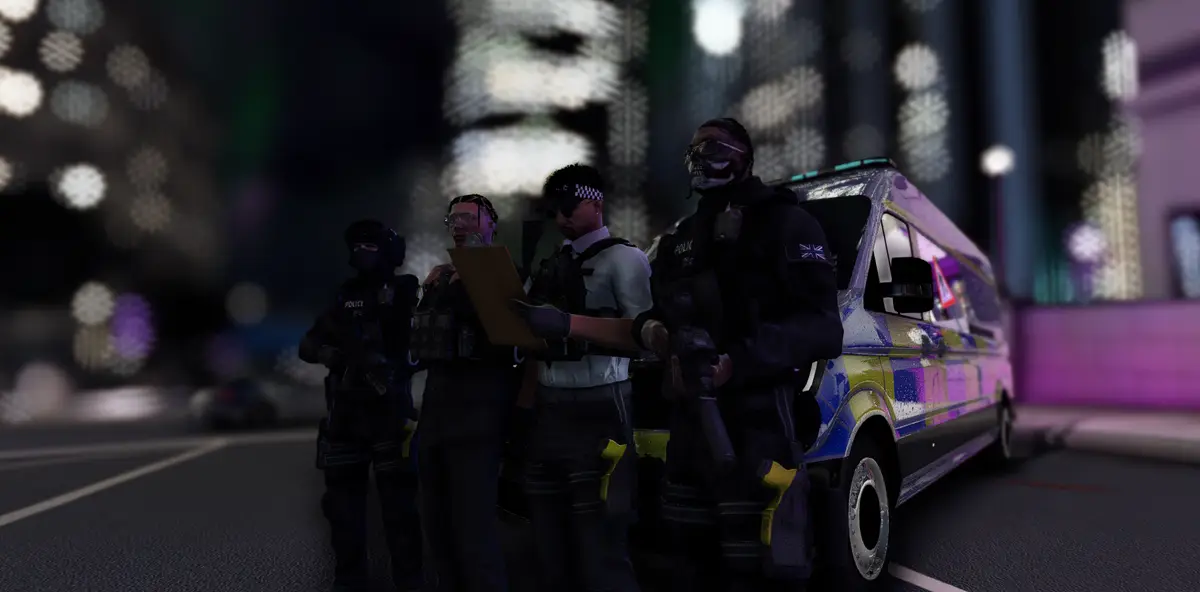 An armed Drill UK police unit standing beside their liveried van on a city street at night