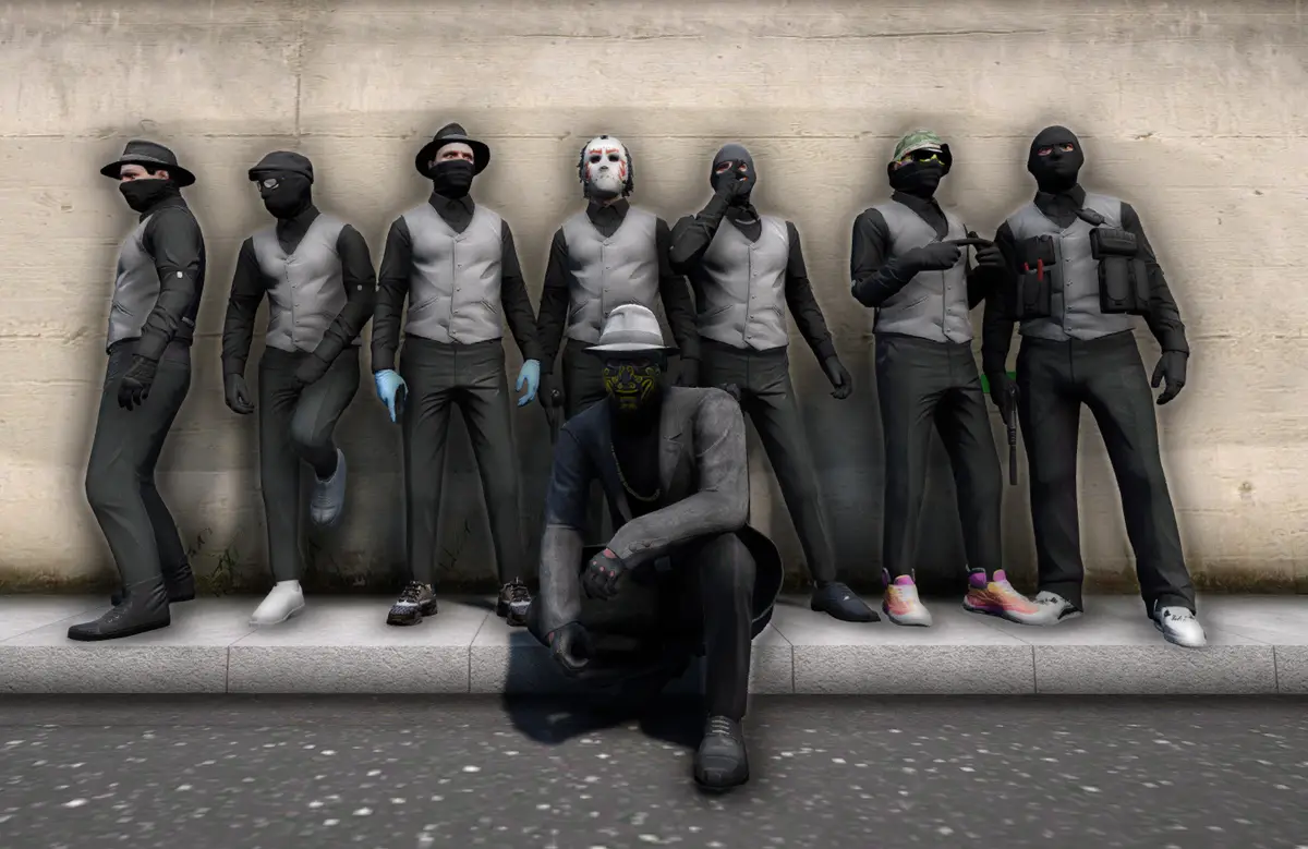 A Drill UK crew in matching grey waistcoats and masks lined against a wall